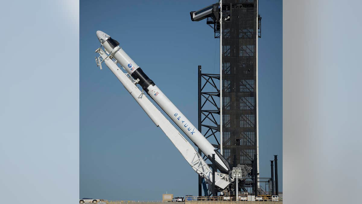 SpaceX Falcon Heavy rocket positioned on pad at LC-39A.