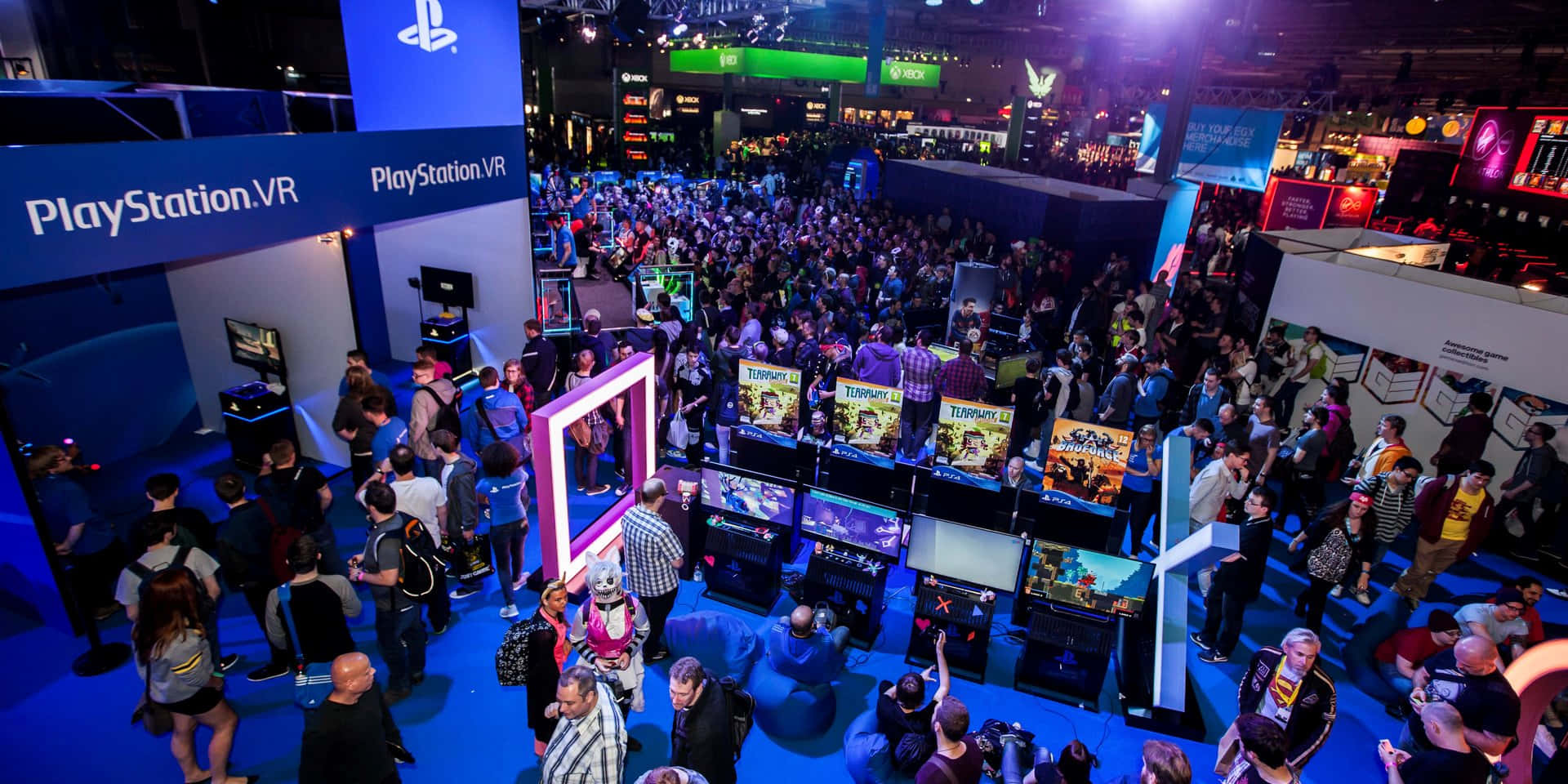 Crowds gathered around gaming exhibition booths on the convention floor.