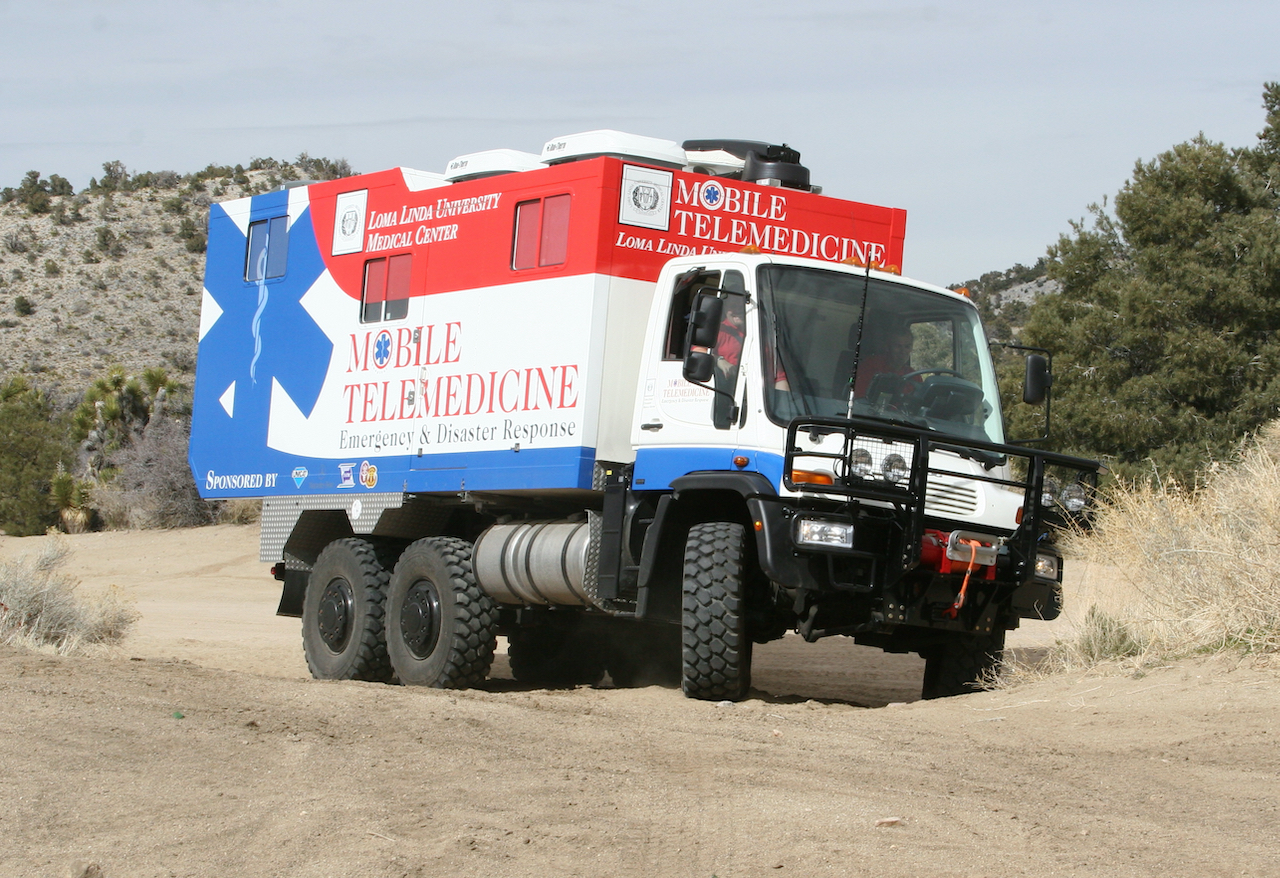 A Loma Linda University Medical Center Mobile Telemedicine emergency and disaster response vehicle deployed in an arid outdoor setting.
