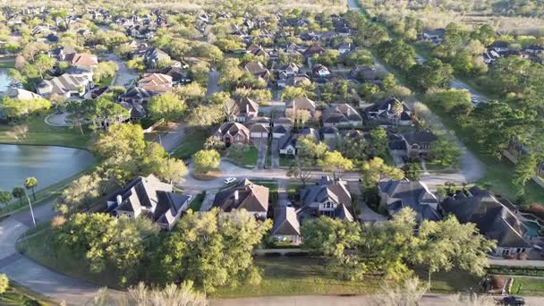 Aerial view of a suburban residential neighborhood featuring single-family homes and winding streets.