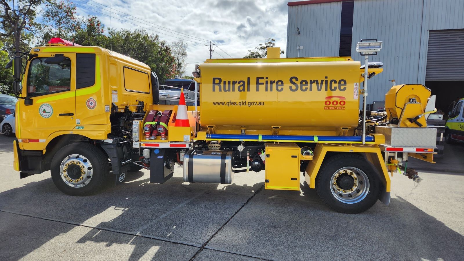 A yellow Rural Fire Service truck parked outside.