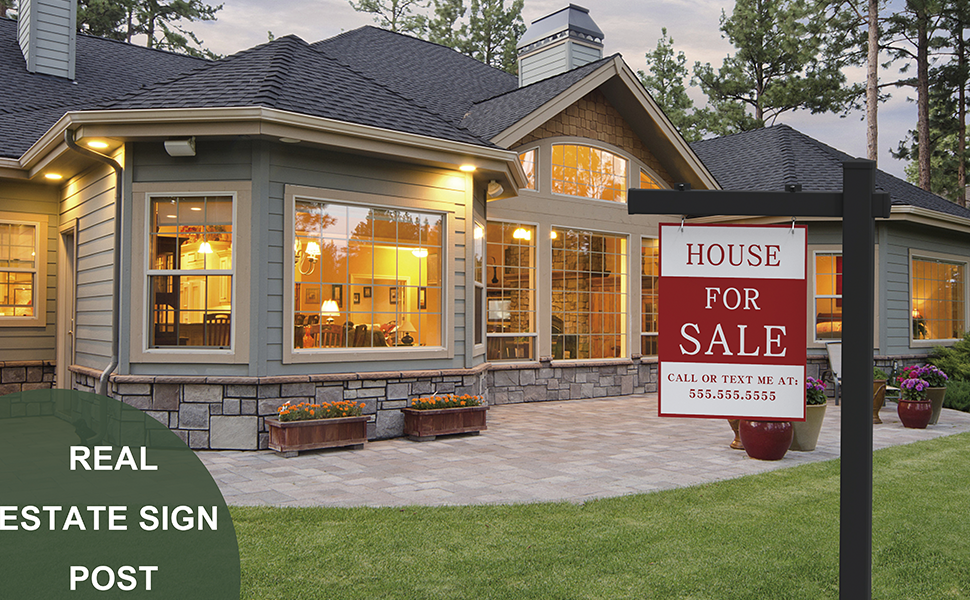 A real estate sign posted on the front lawn of a suburban house.