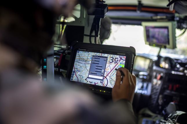 Close-up of digital radar maps and tracking interfaces on computer displays.