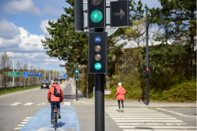 Bicycle lane infrastructure alongside a busy urban roadway.