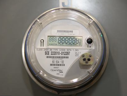 A digital smart utility meter displaying energy consumption data.