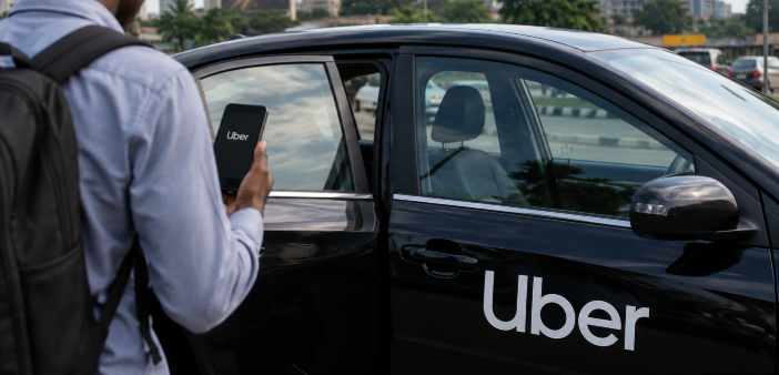 A black Uber car with a man holding a mobile phone